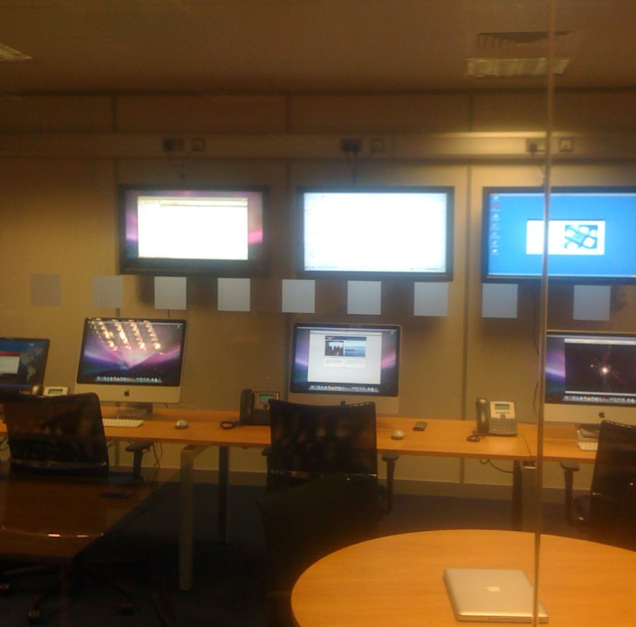 Two technicians working on a cell tower against a cloudy sky, Belgrade.